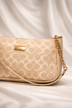 Compact beige printed bag showing gold Detailing and stylish finish for women