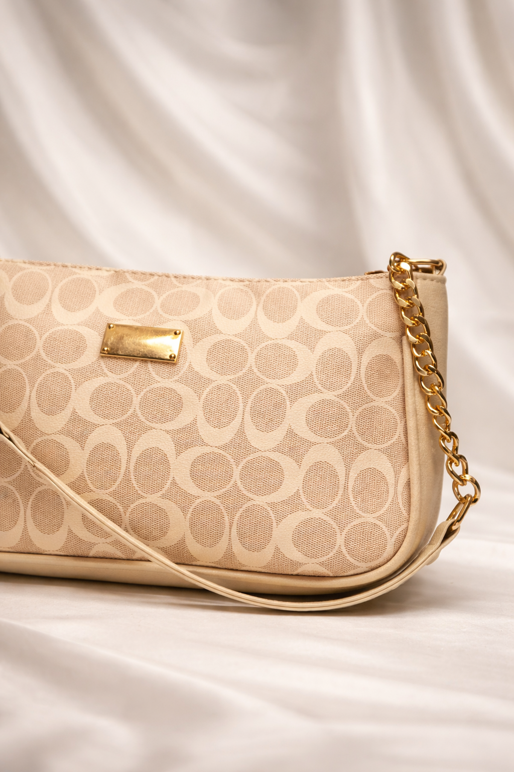 Compact beige printed bag showing gold Detailing and stylish finish for women