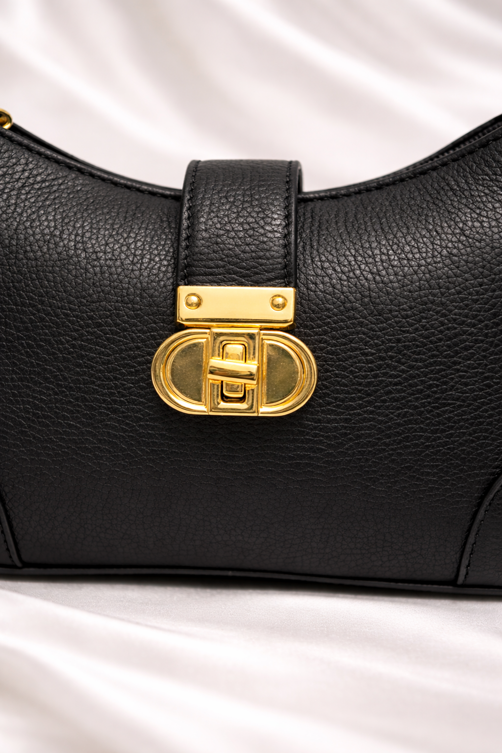 High quality pebbled leather texture and golden zipper detail on Silslah black sling modern bag