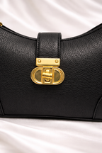High quality pebbled leather texture and golden zipper detail on Silslah black sling modern bag