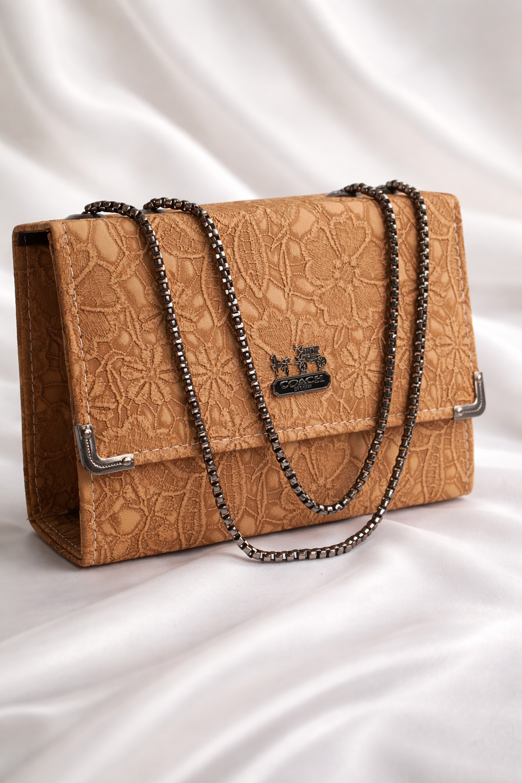 Sophisticated caramel tan handbag with floral patterns and gold hardware details for office use
