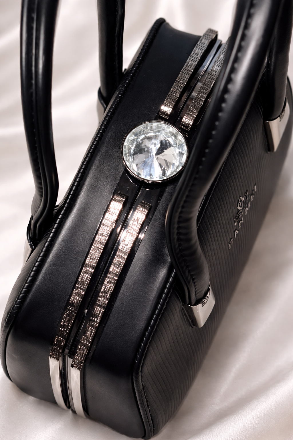 Black gunmetal crescent moon rings and vertical stripe texture on luxury black bag with handles perfect for party wear