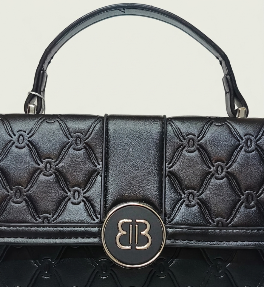 Black quilted handbag with a brand logo on a light gray background