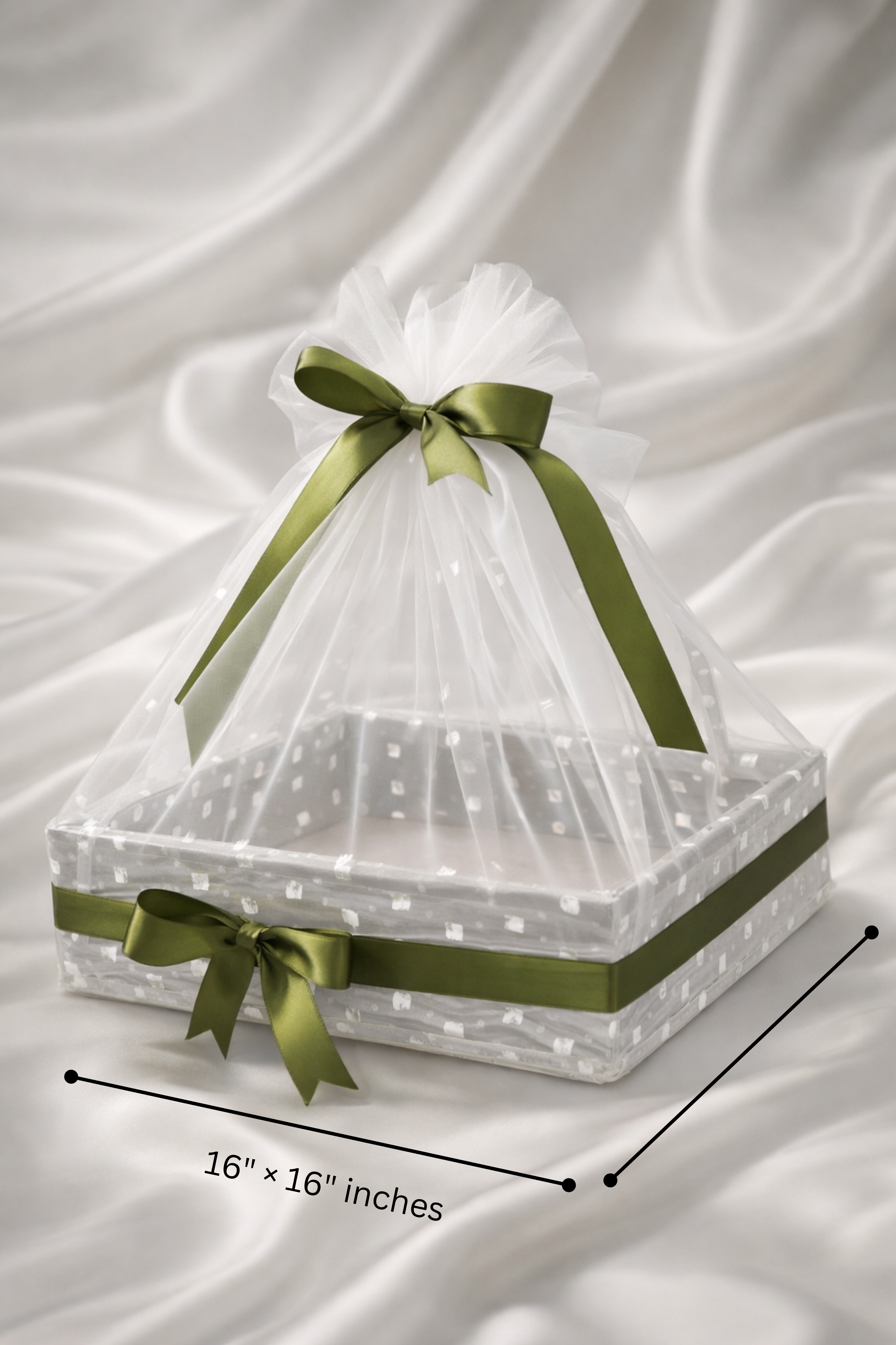 Decorative basket with green ribbons and sheer fabric on a white background