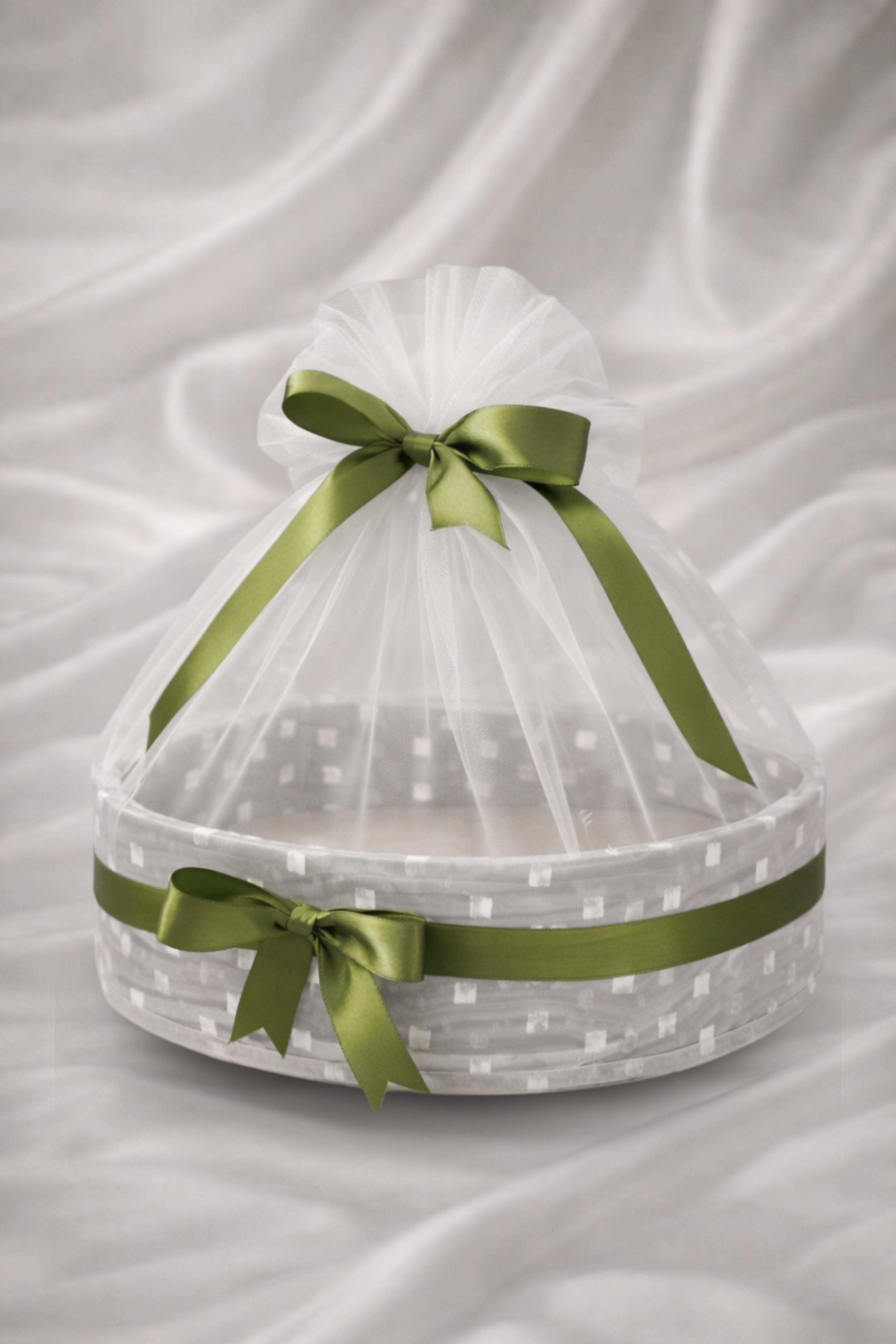 Decorative basket with green ribbons on a white background
