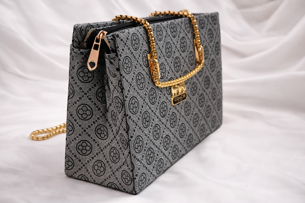 Close up of signature grey monogram print on high quality faux leather handbag