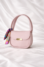 Close up of silk scarf handle and gold hardware on Silslah mini handbag