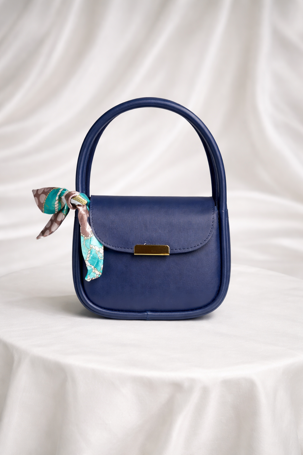Mini designer handbag for girls with gold clasp and decorative floral scarf accessory