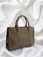 Side view of mushroom brown leather-style tote bag showing sturdy handles and clean finish