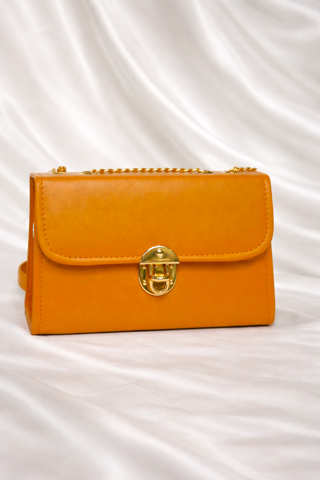 Stylish mustard amber handbag for women in Pakistan with premium gold detailing and elegant top handle design - Silslah Store