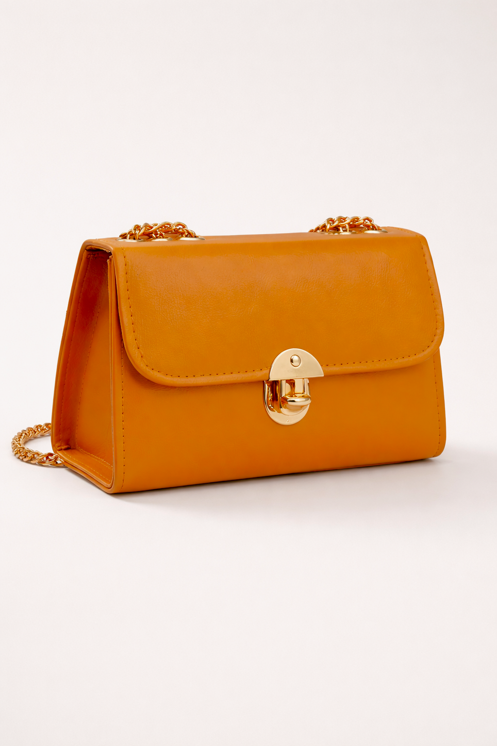 Mustard shoulder bag for girls with shiny gold accents and smooth faux leather finish ideal for party and formal wear in Pakistan
