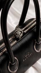 Close-up of rhinestone frame and pearl connector handles on Silslah black luxury handbag 