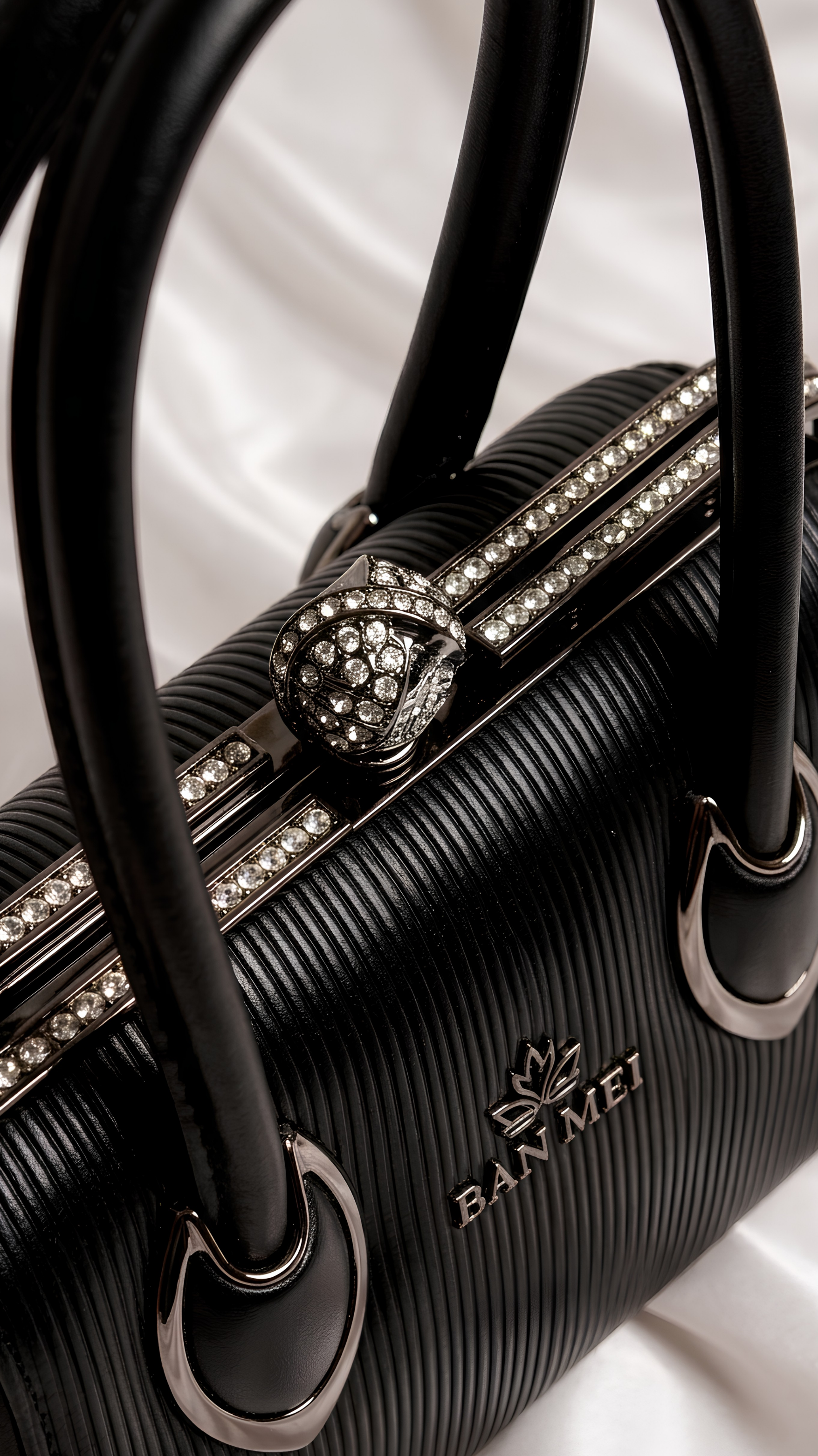 Close-up of rhinestone frame and pearl connector handles on Silslah black luxury handbag 