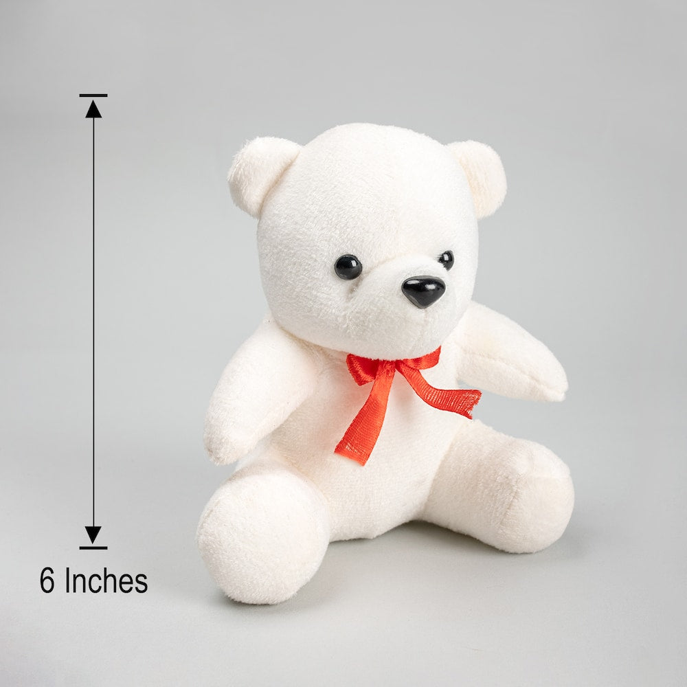 White teddy bear with a red bow and measurement label on a gray background